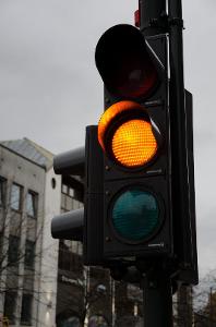 What does a yellow traffic light indicate?