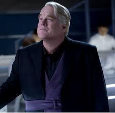 What did Plutarch Heavensbee fall into after Katniss shot the arrow at the pig?