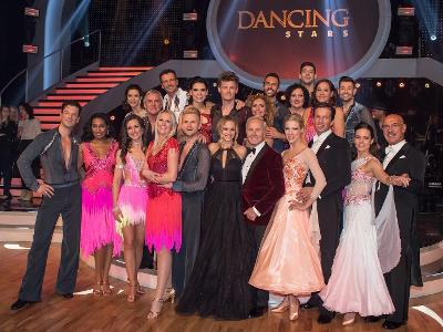 Which show involves celebrities paired with professional dancers in a ballroom competition?