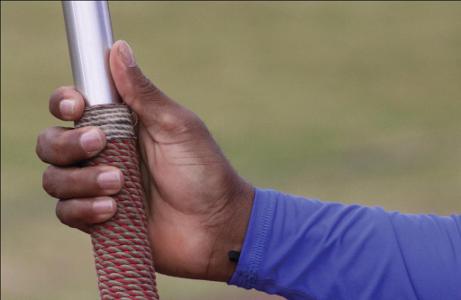 What is the correct grip for holding a cricket bat?