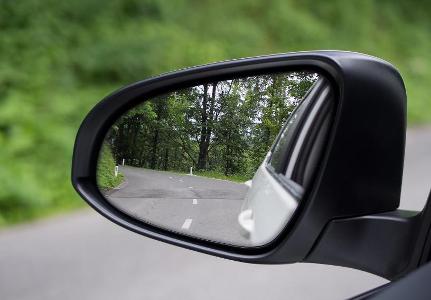 What is the purpose of side view mirrors on a car?