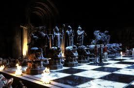 when leading harry and hermione in a game of wizards chess which position does Ron say he will take?
