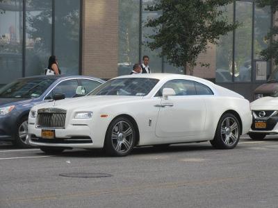 Which luxury car brand is known for its ultra-luxurious and handcrafted vehicles like the Ghost and Wraith?