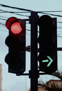 What does a black traffic signal with a left arrow indicate?
