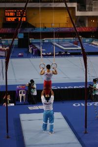 In artistic gymnastics, what is the maximum number of competitors allowed per team in Olympic competition?