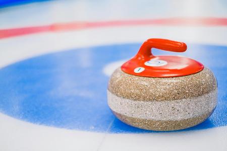 What material is the running surface of a curling stone made of?