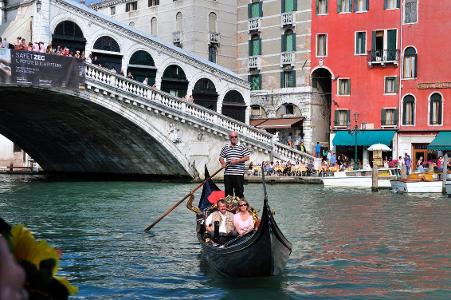 Which city is famous for its canals and gondolas?