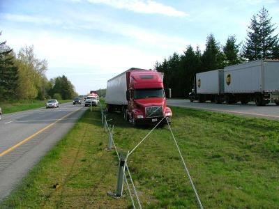 What should you do if you notice a large commercial truck merging onto the highway?