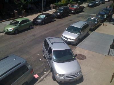 How much space should be left between your car and the vehicles in front and behind when parallel parking?