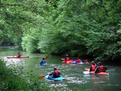 What is a common hazard to look out for when canoeing in rivers?