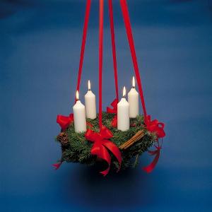 Traditionally, an Advent Wreath in Denmark is made out of fine spruce twigs and cuttings. It is also often decorated with red berries and spruce cones. What is then added for decoration?