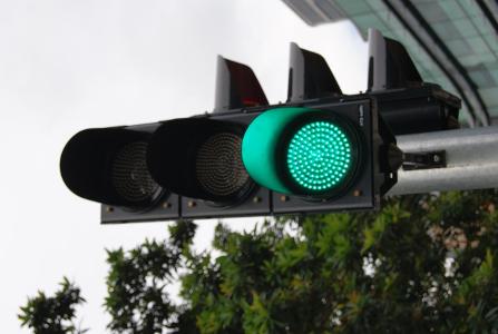 What does a steady green traffic light indicate?