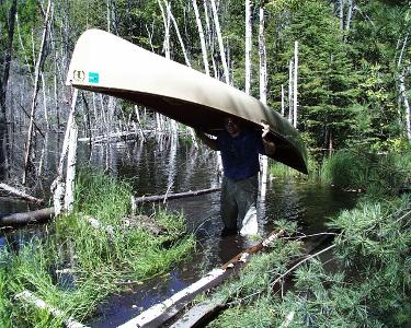 What is the purpose of a portage in canoeing?