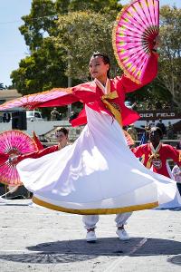 What type of Folk Dance uses umbrella props and is popular in Asian countries?
