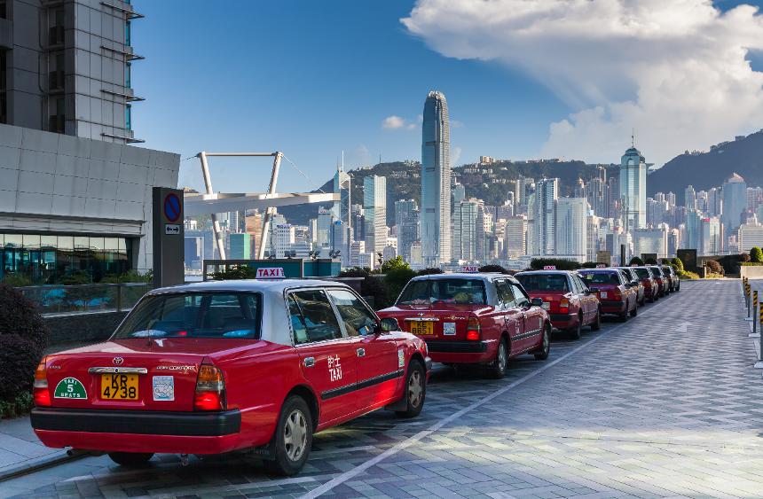 What should you do to reduce idling time and fuel consumption while waiting in your car?