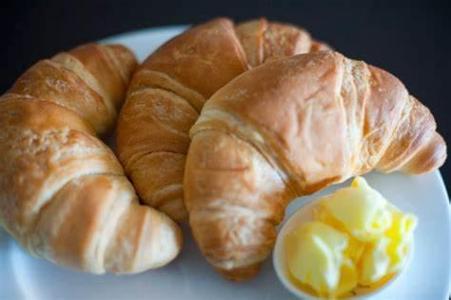 What type of cuisine is associated with croissants and escargot?
