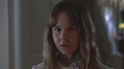 Which horror movie features a possessed child named Regan?