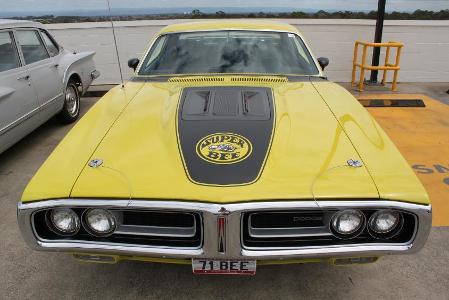 Which muscle car features a Super Bee emblem?