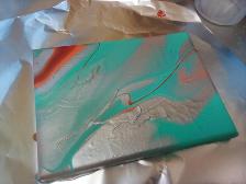 Silver paint pour w/ little red and orange. turqouise. I MADE THIS